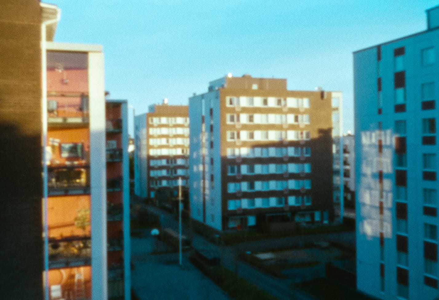 Apartment blocks in low evening sun, on film